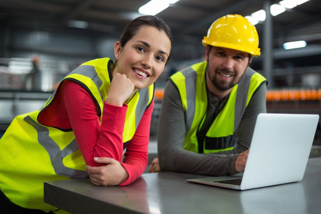 Construction workers reviewing compliance